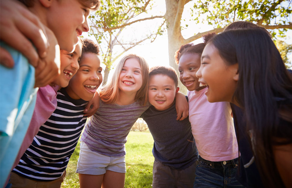 Group of seven students in a circle smiling