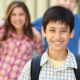 Smiling young school boy with backpack