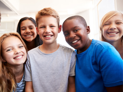 Five happy students smiling