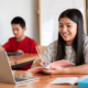 Two students in classroom doing schoolwork